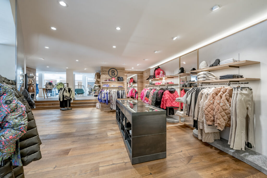 Riml Sports Telfs clothing store interior with jackets, coats, and sweaters on display.